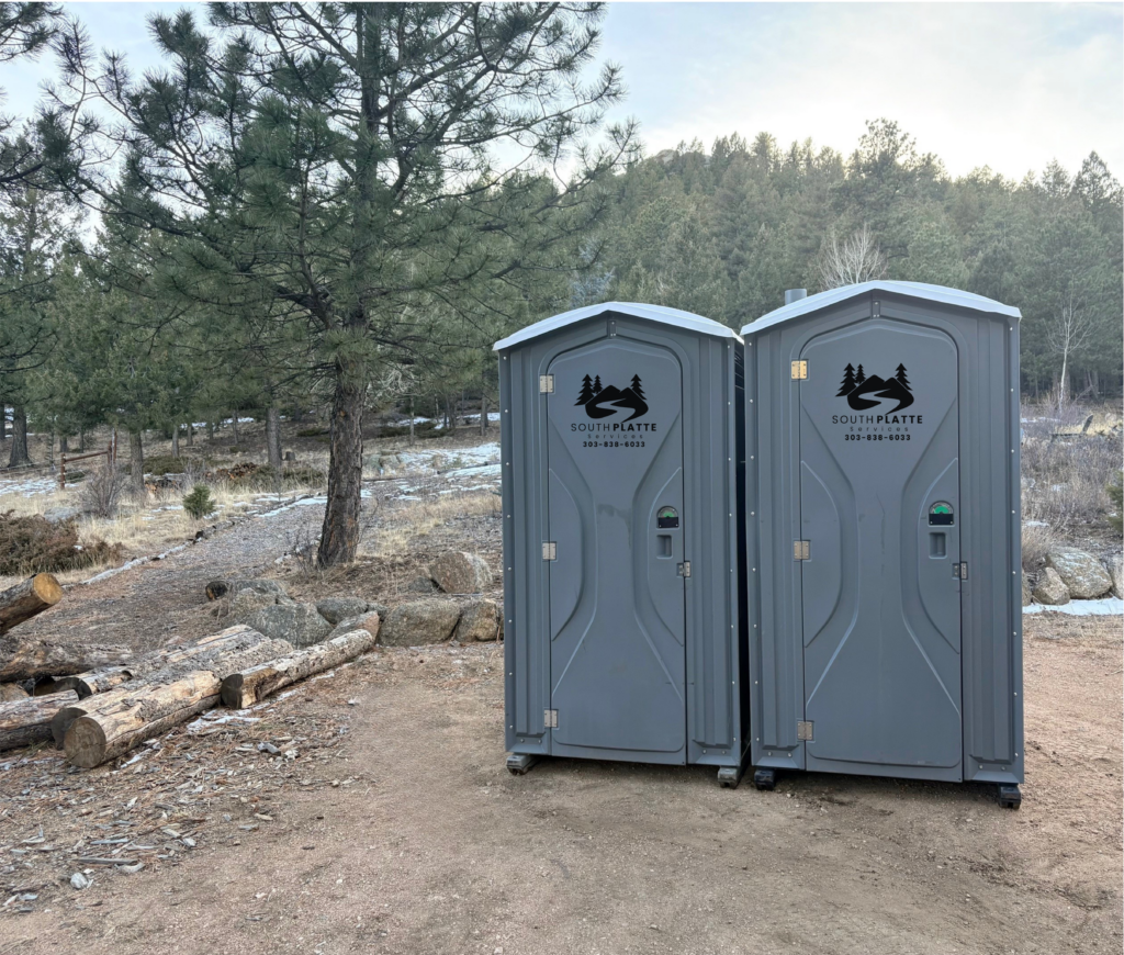Two South Platte Services, LLC portable toilets sit at a trailhead along the 285 corridor.